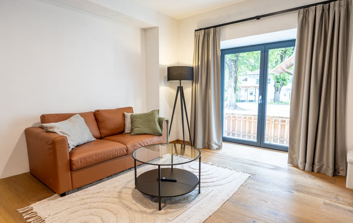 Sofa and balcony doors in the two-bedroom apartment