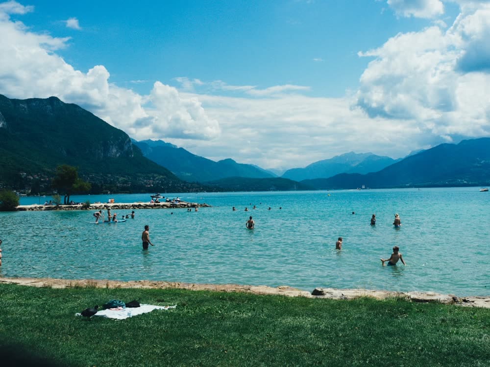 Swimmers in a clear alpine lake