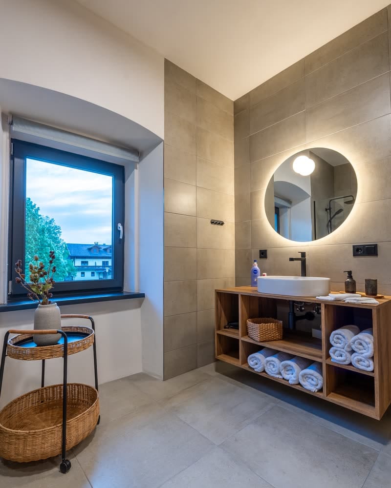 Bathroom with a walk-in shower and a window